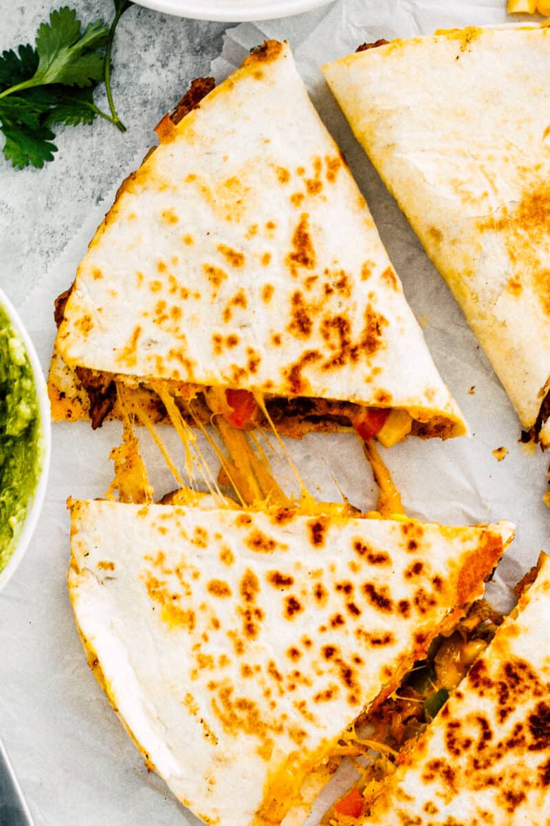 up close overhead image of chicken quesadilla on parchment