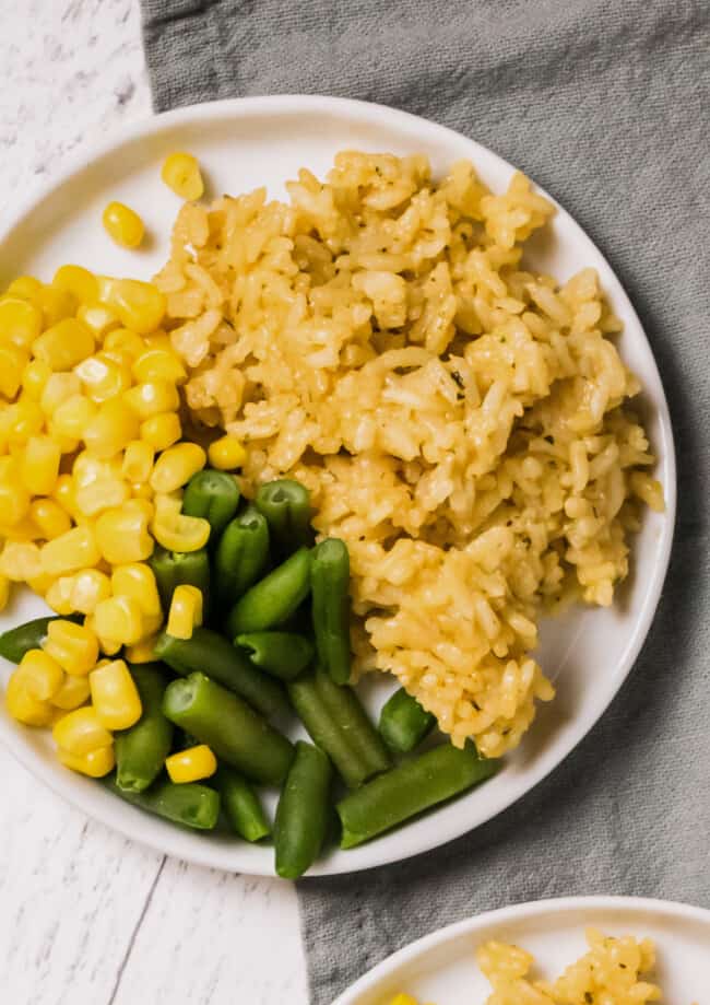 plate with chicken rice, green beans, and corn