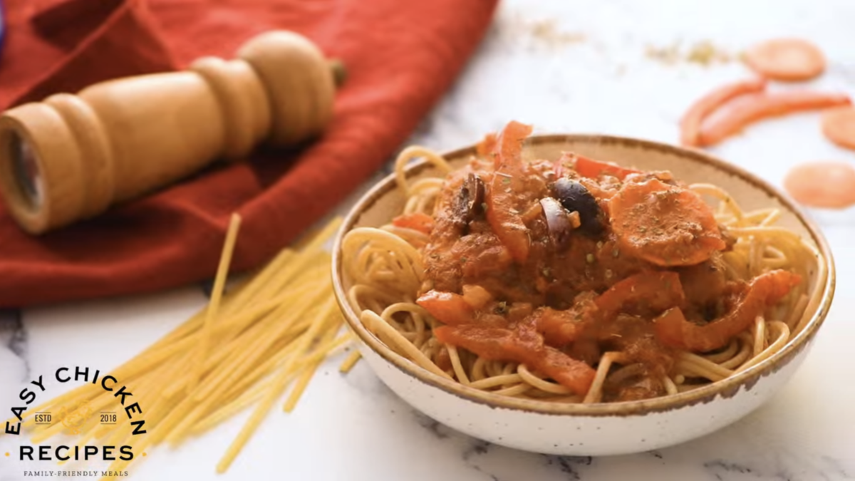 Chicken cacciatore with pasta is placed in a small bowl. 