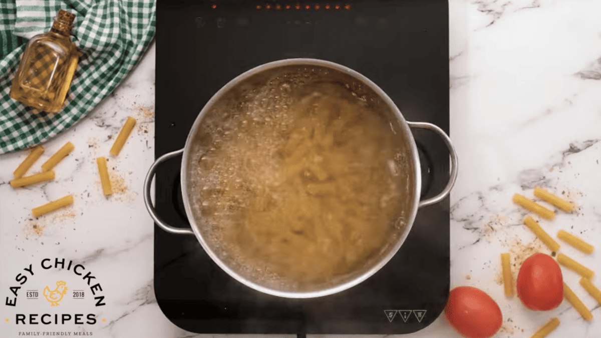 Ziti is cooking in a pot of boiling water