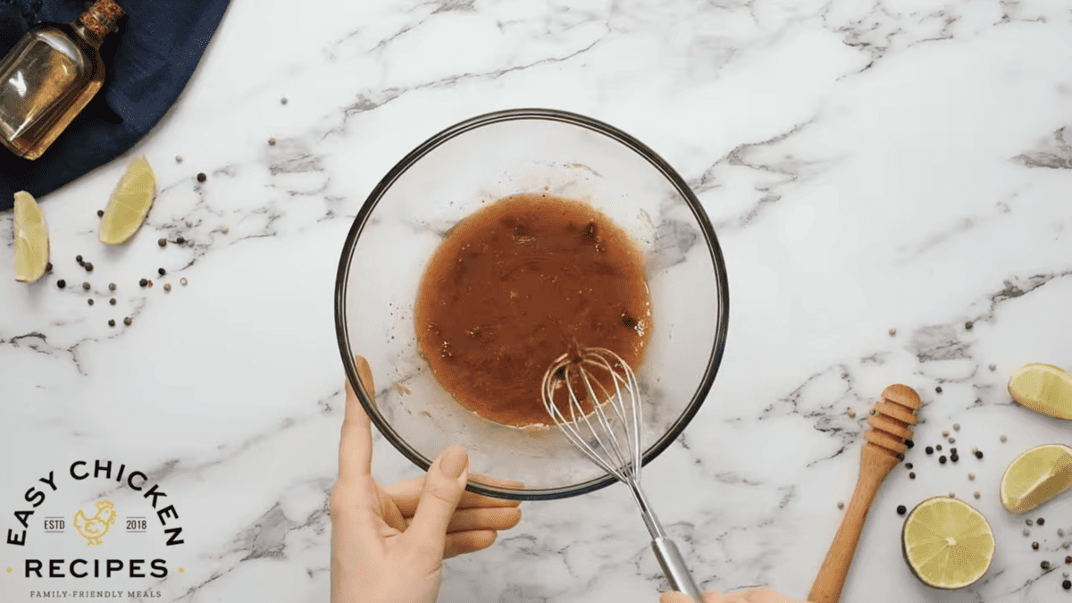 A person is whisking a Chipotle Chicken sauce into a bowl.