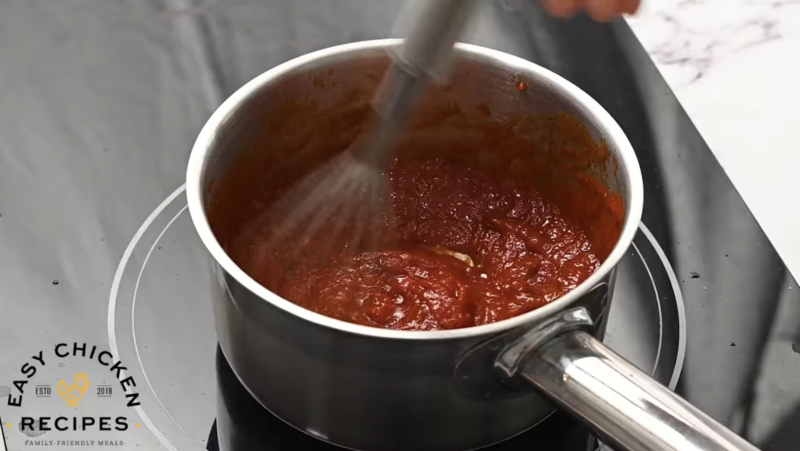 Chipotle sauce is being cooked on a stove top.