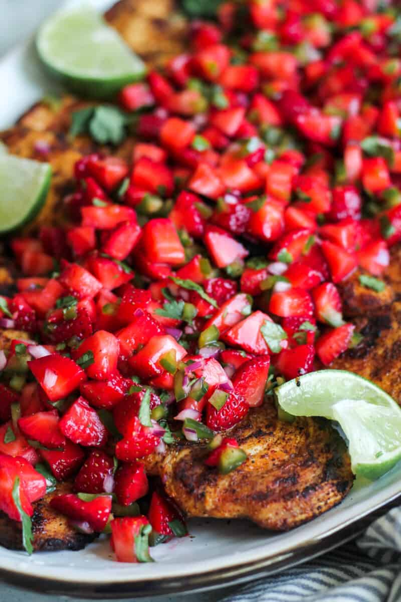 up close image of strawberry salsa topping grilled chicken