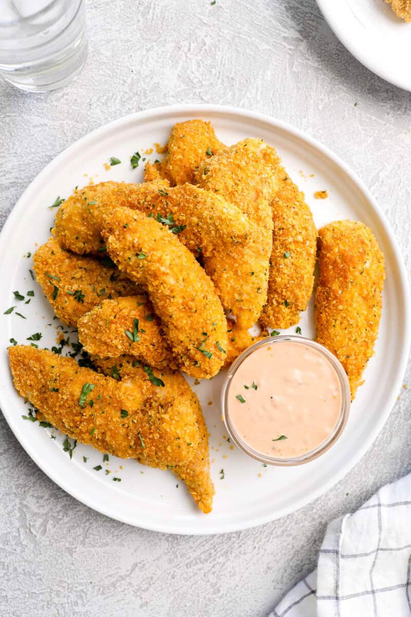 baked chicken tenders on plate with special sauce