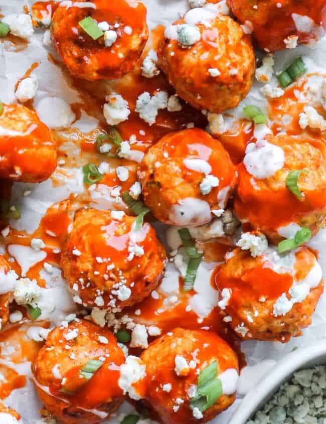 up close image of buffalo chicken meatballs drizzled with ranch