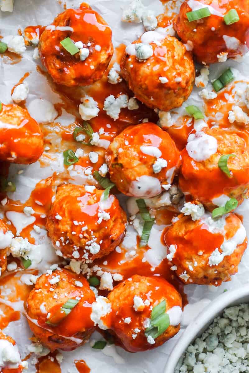 up close image of buffalo chicken meatballs drizzled with ranch