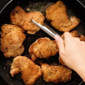 seared chicken thighs in a pan.
