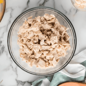 shredded cooked chicken in a bowl.