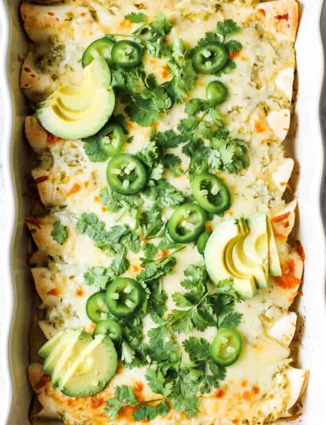 green salsa verde enchiladas topped with jalapenos