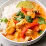side image of thai red curry chicken in bowl with rice