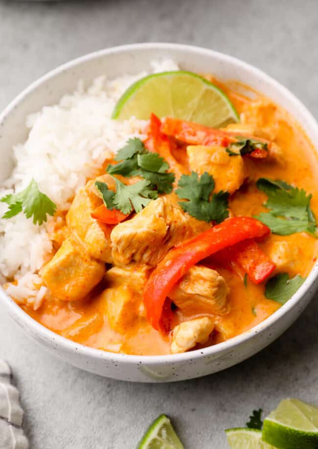 side image of thai red curry chicken in bowl with rice