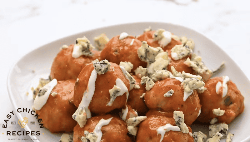 Buffalo chicken meatballs are topped with blue cheese.
