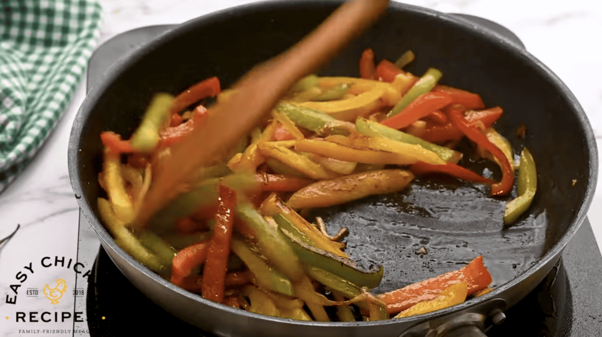 Veggies are being cooked in a skillet. 