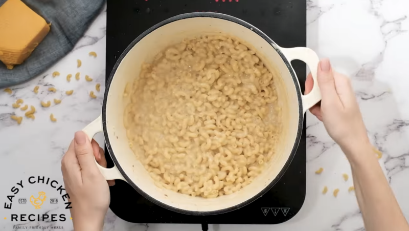 A pot is filled with cooked macaroni in a creamy sauce.