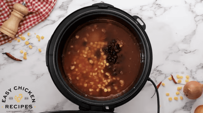 The ingredients for chicken chili are placed in the Instant Pot.