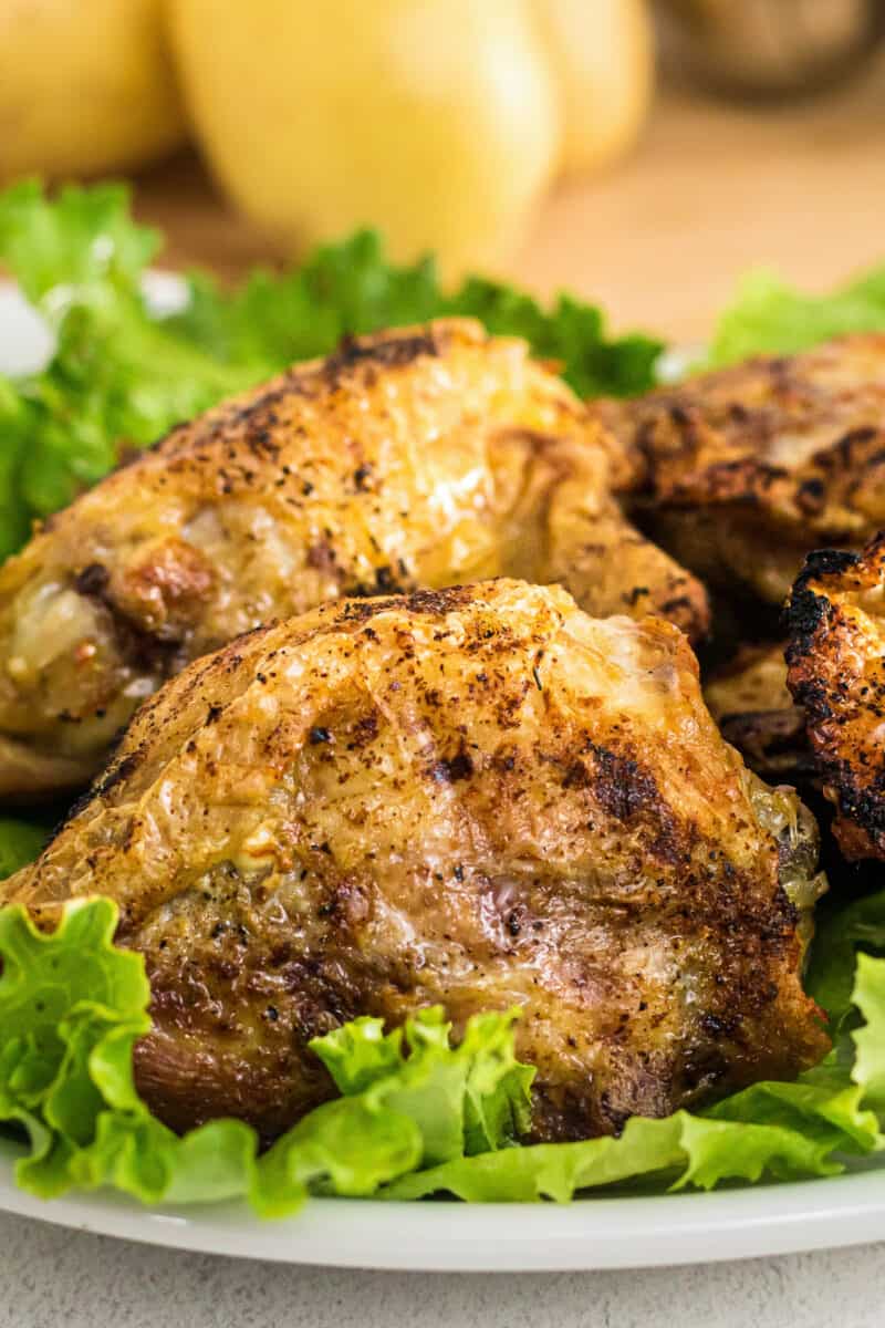 air fried chicken thighs on bed of lettuce