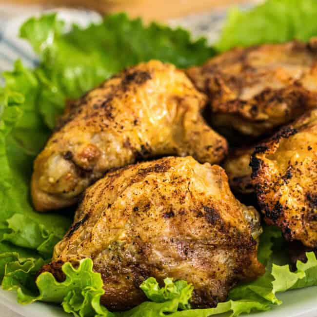 air fried chicken thighs on bed of lettuce