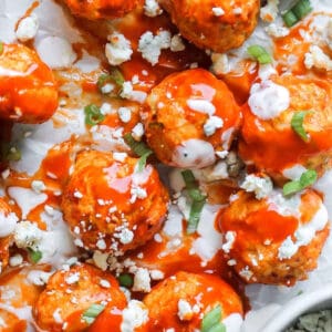 Buffalo chicken meatballs drizzled with buffalo sauce, blue cheese crumbles, and green onions.