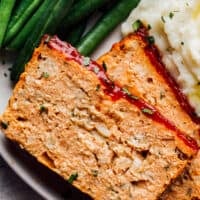 chicken meatloaf on plate with green beans and mashed potatoes
