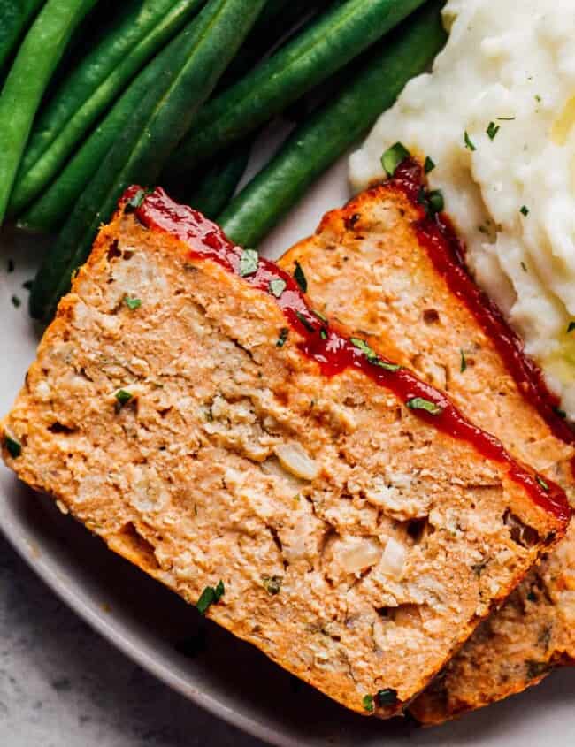 chicken meatloaf on plate with green beans and mashed potatoes