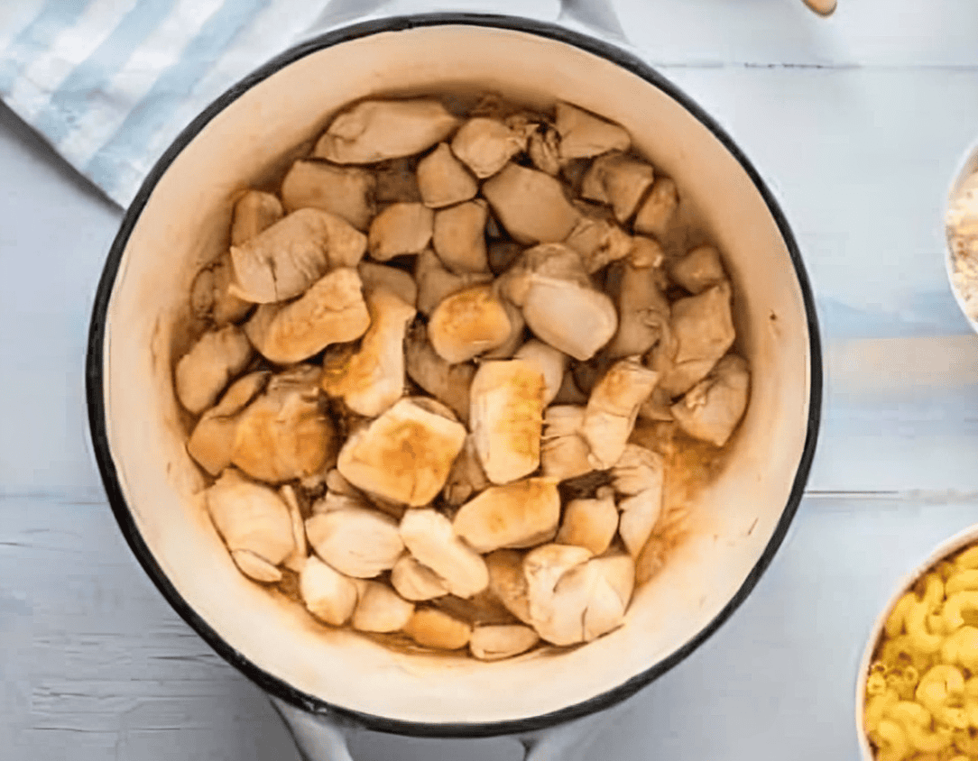 cooked chicken pieces in a pot.