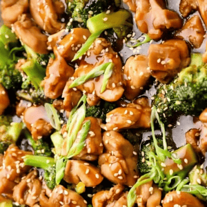 teriyaki chicken thighs and broccoli in a pan.