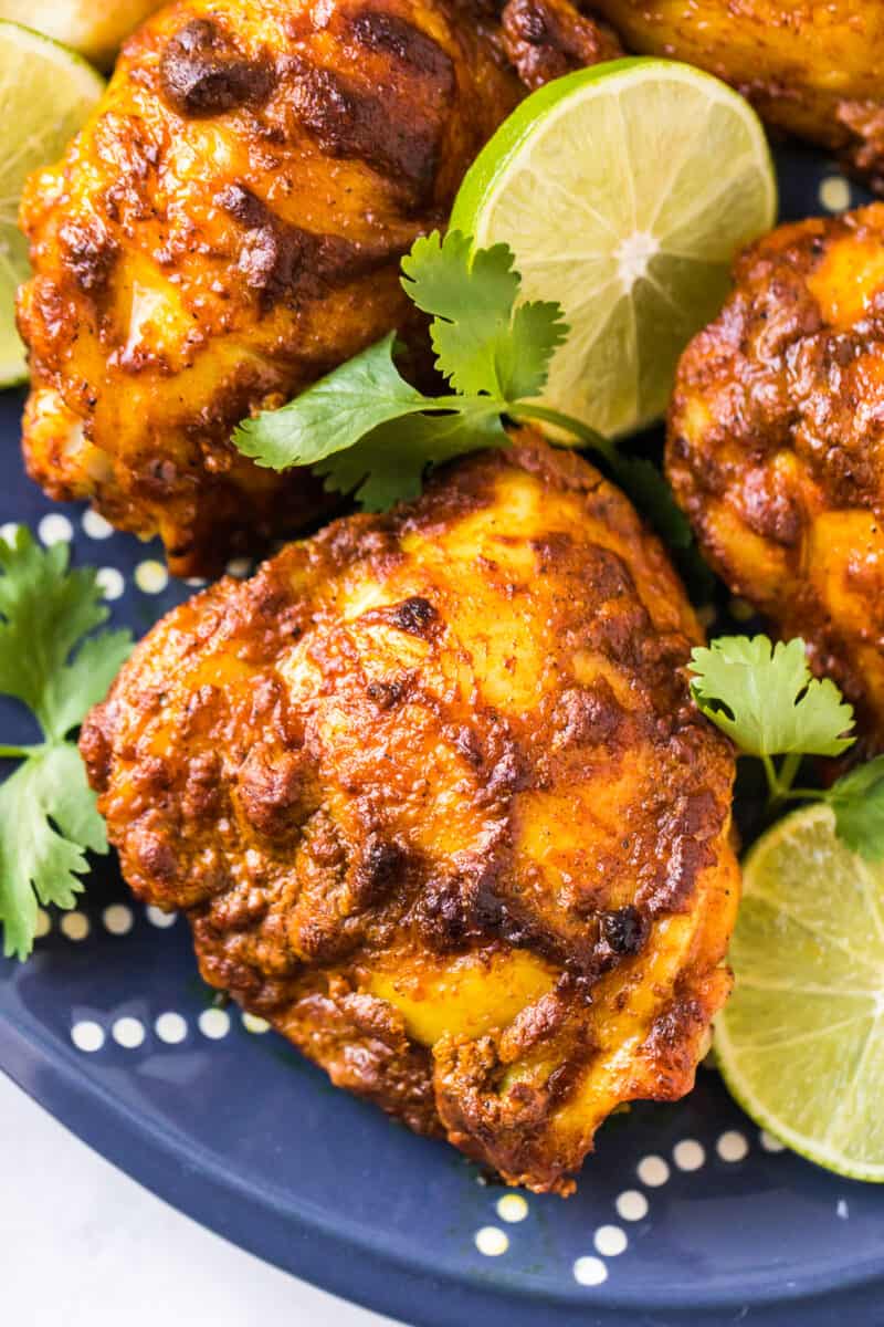 up close image of chicken thighs marinated in tandoori marinade