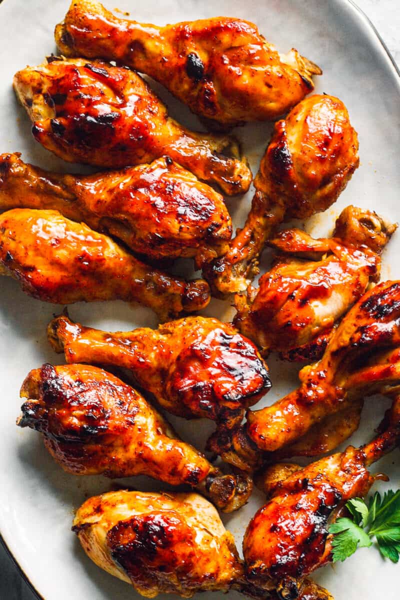 up close image of bbq chicken drumsticks on plate