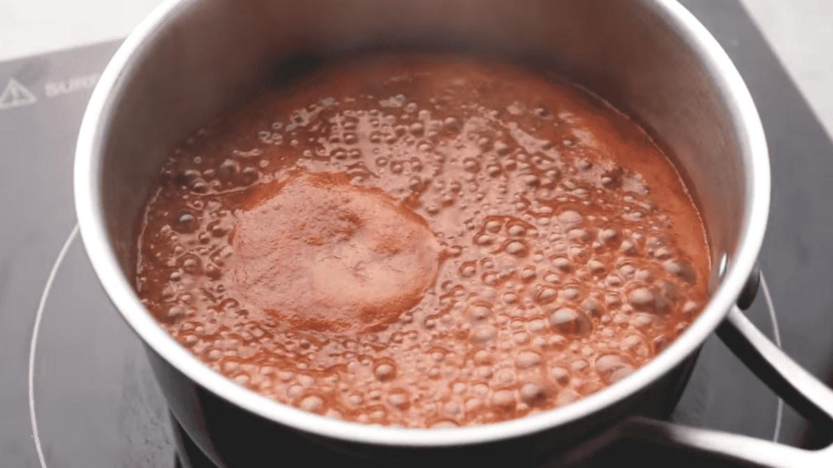 BBQ sauce is cooking in a saucepan. 