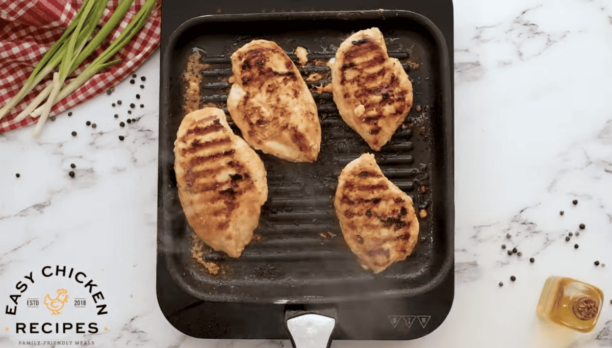 Chicken breasts are being grilled. 