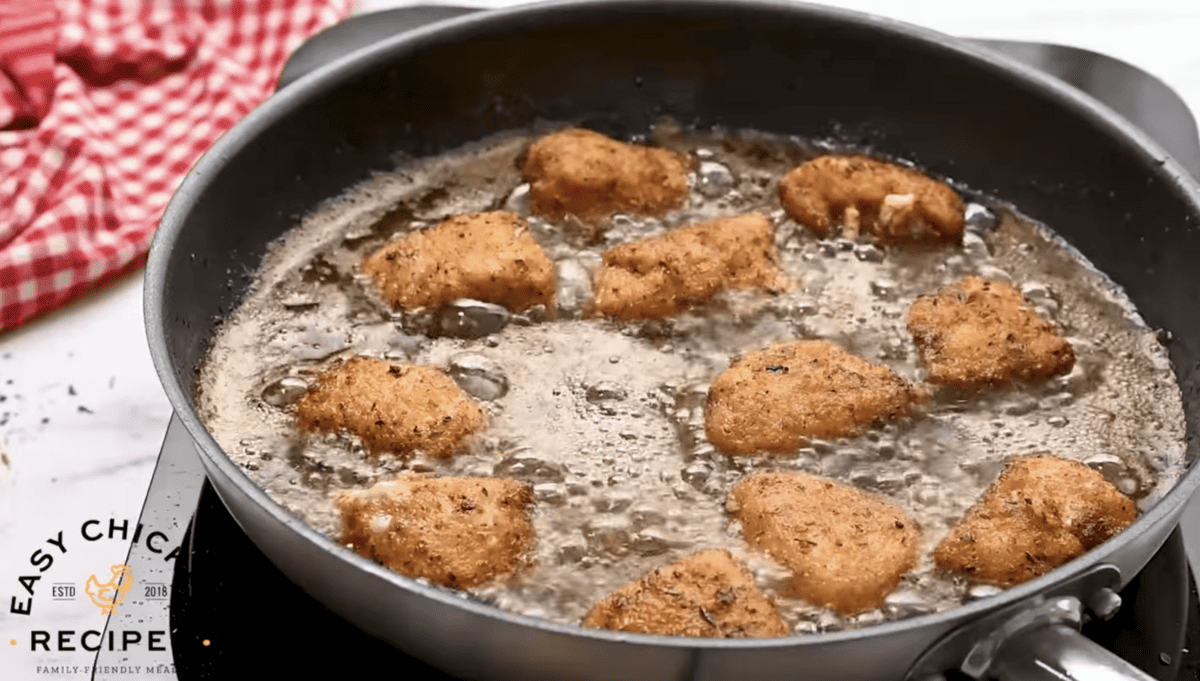 Chicken nuggets are being fried in hot oil. 