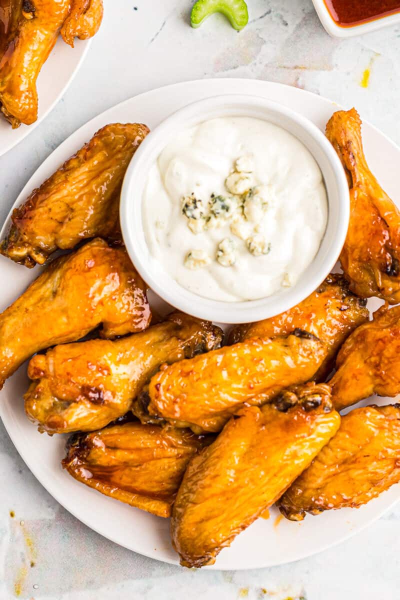 air fryer buffalo chicken wings next to blue cheese dressing