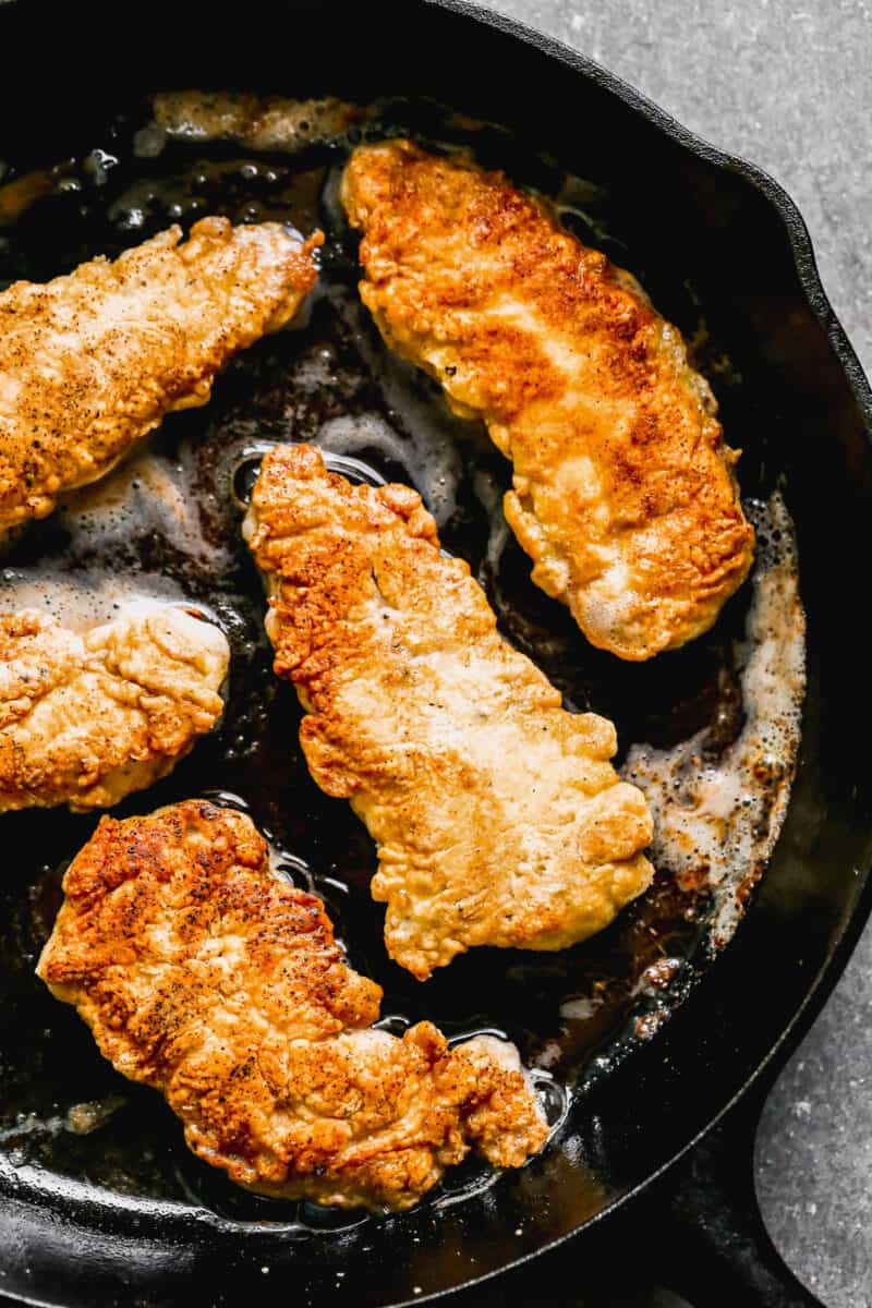 frying chicken in skillet