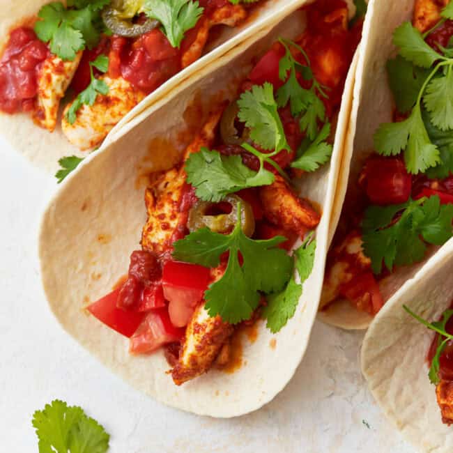 chicken tacos topped with cilantro.