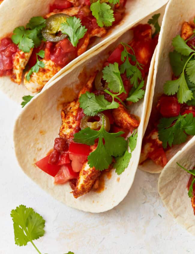 chicken tacos topped with cilantro.