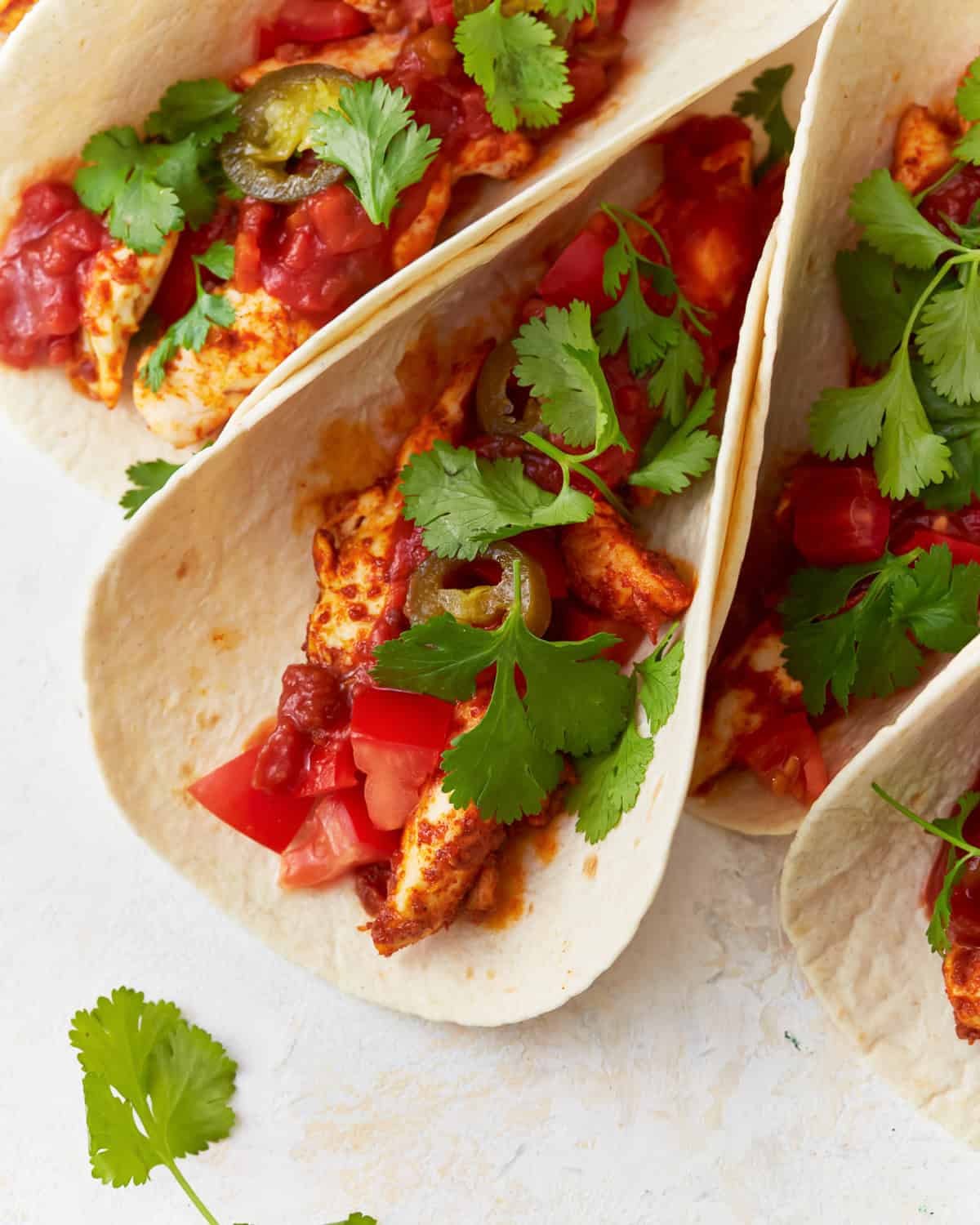 chicken tacos topped with cilantro.