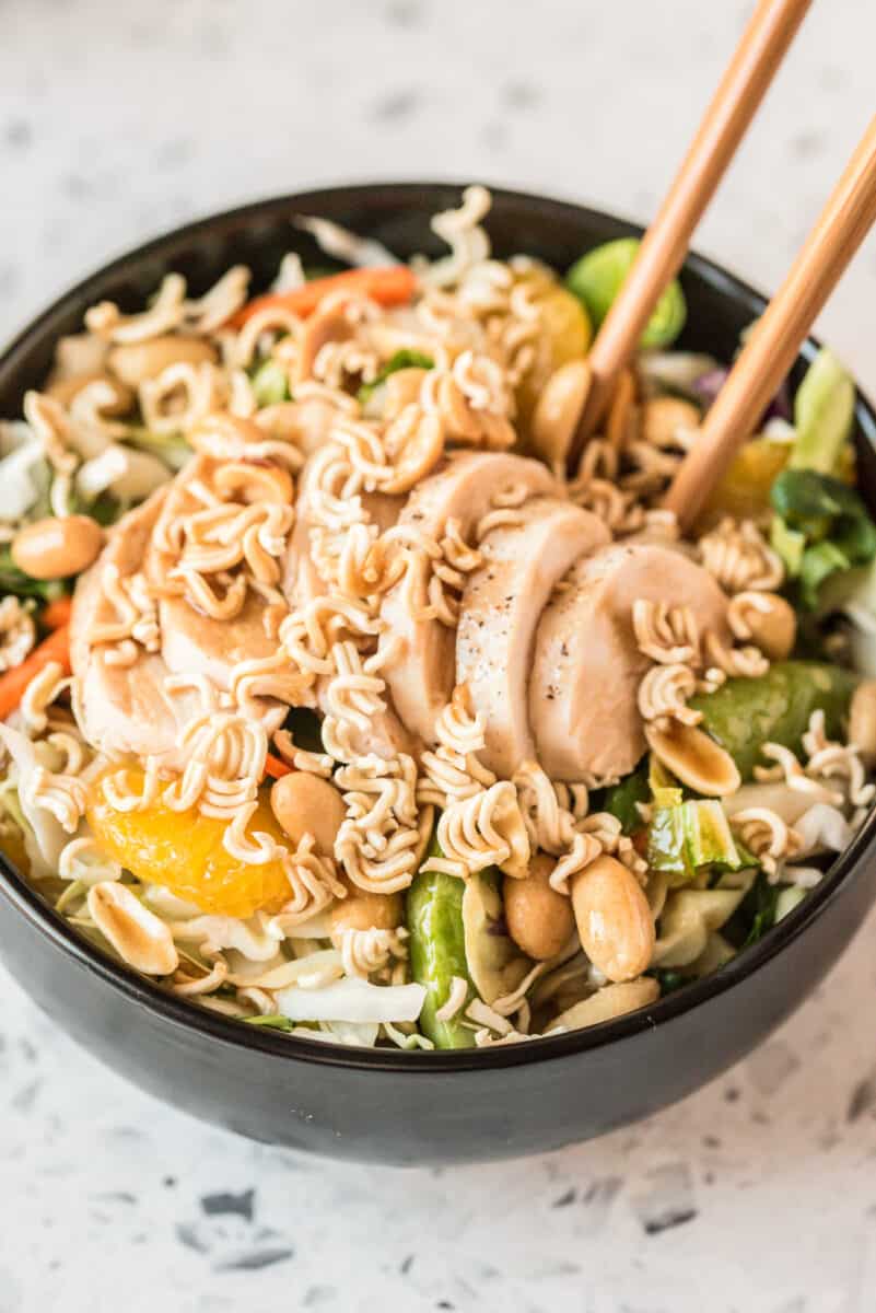 chinese chicken salad in bowl with chopsticks