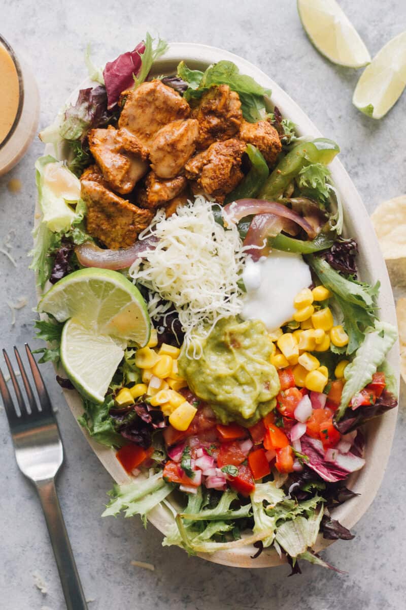 chipotle mexican chicken salad with toppings in bowl