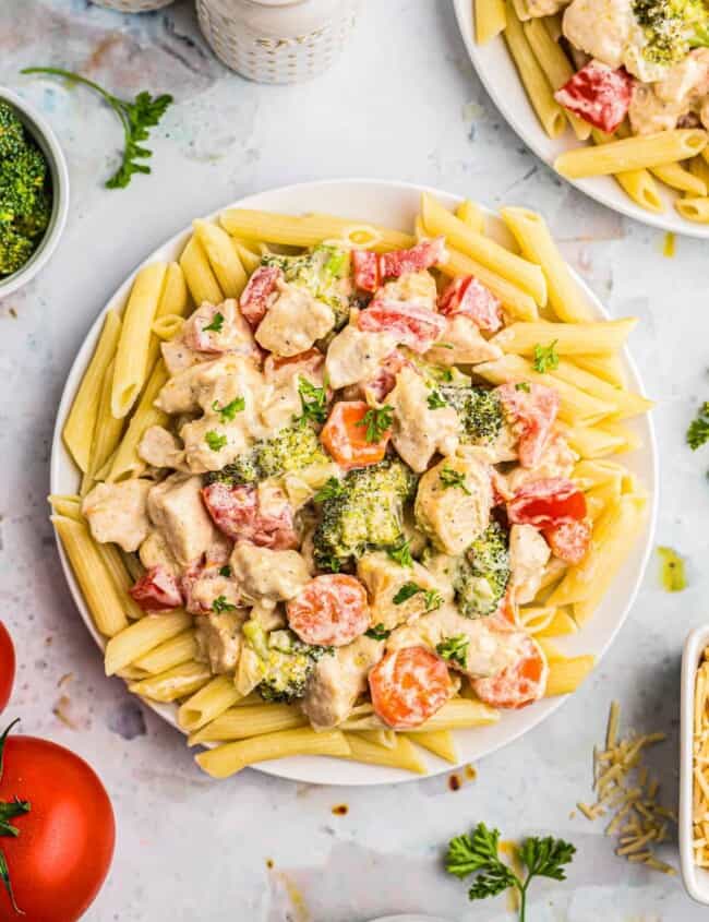 chicken primavera over pasta on plate