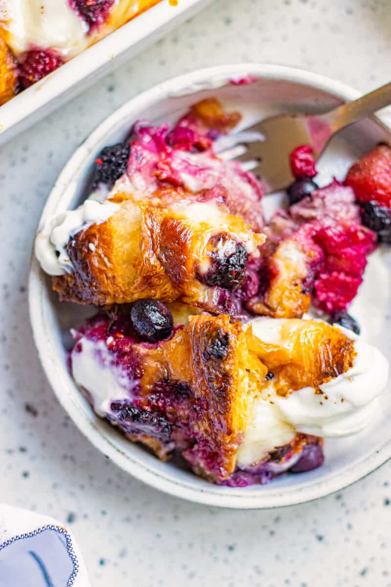 french toast casserole on plate with berries