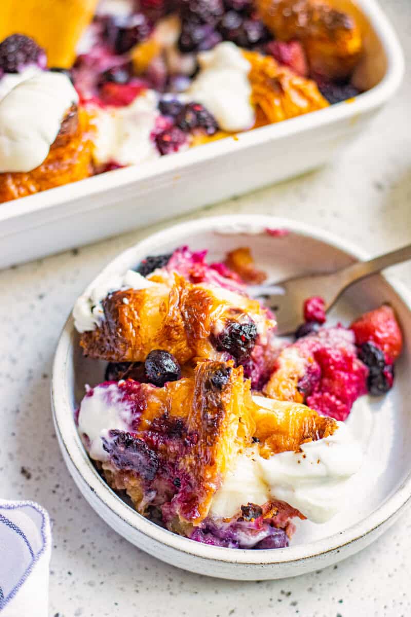 french toast casserole on plate with berries