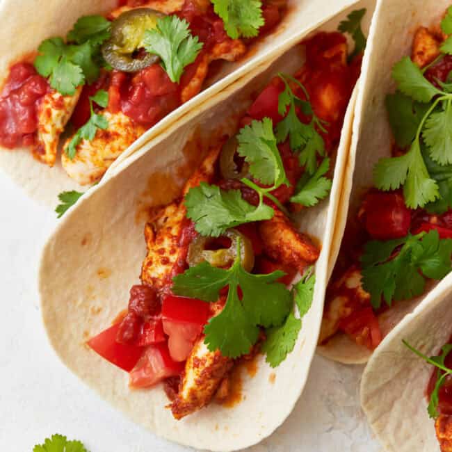 chicken tacos topped with cilantro.