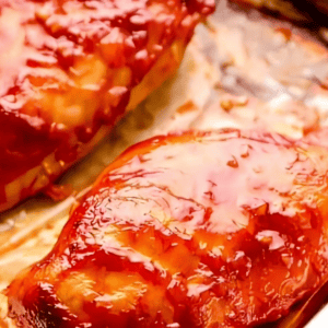 baked bbq chicken breasts on a baking sheet.