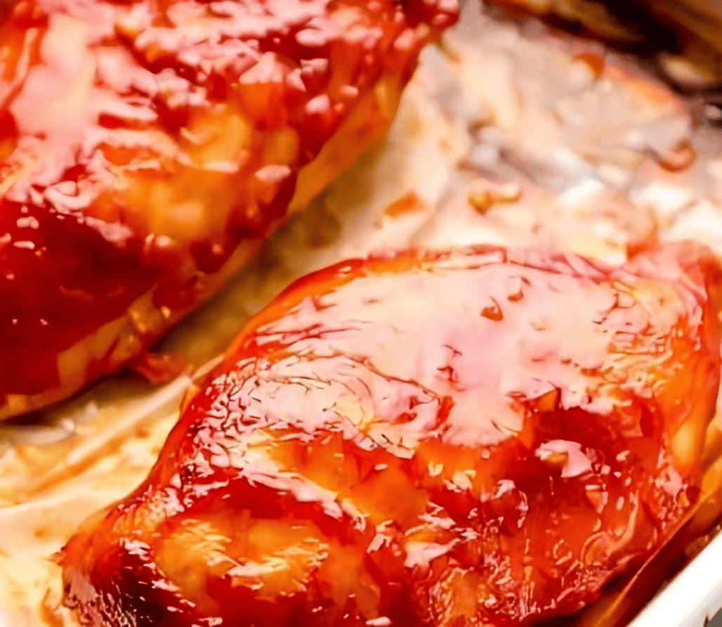 baked bbq chicken breasts on a baking sheet.