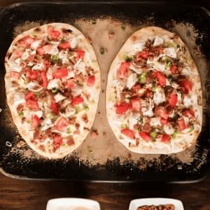 white chicken pizza on a baking sheet.