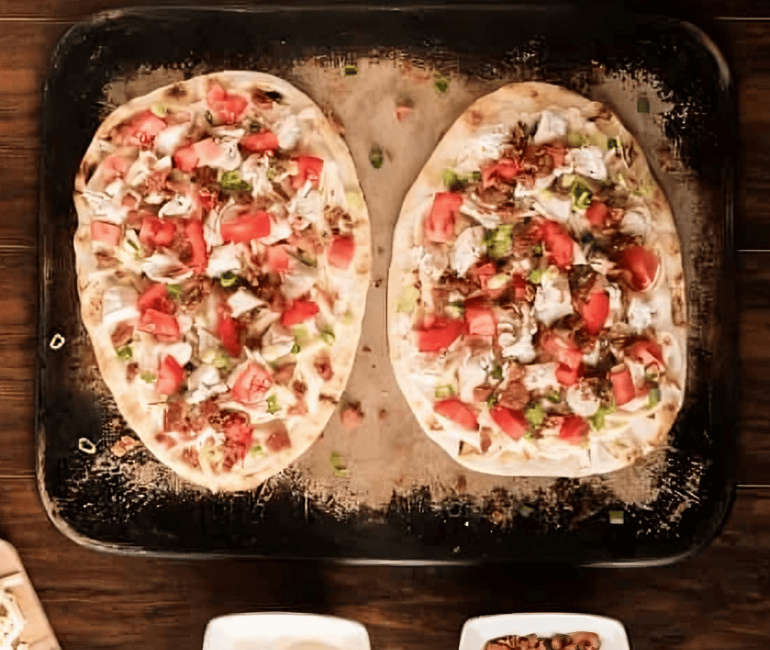 white chicken pizza on a baking sheet.