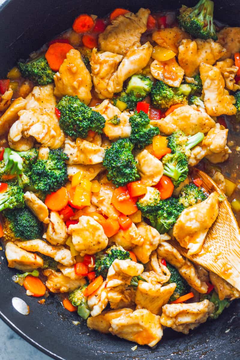 hunan chicken with wooden spoon in skillet