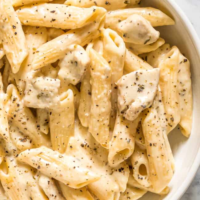 up close image of cheesy chicken pasta in bowl