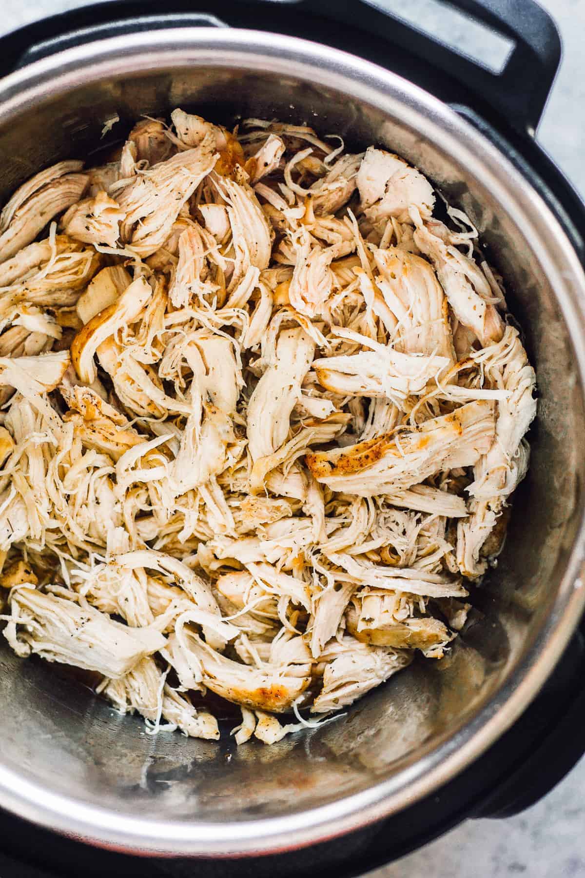 Chicken breasts shredded up in an Instant Pot.