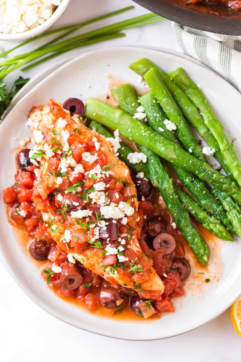 Mediterranean chicken topped with feta next to green beans
